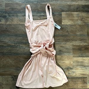 This is a mini wrap dress with a side tie and double square neckline.